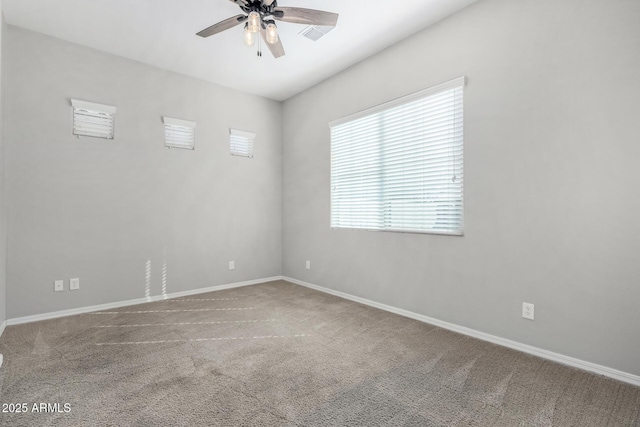 carpeted spare room with ceiling fan