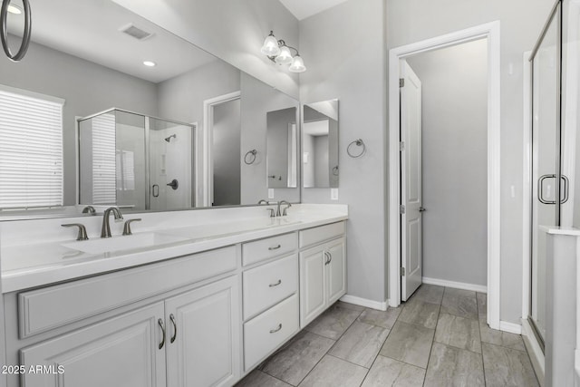 bathroom featuring vanity and a shower with shower door