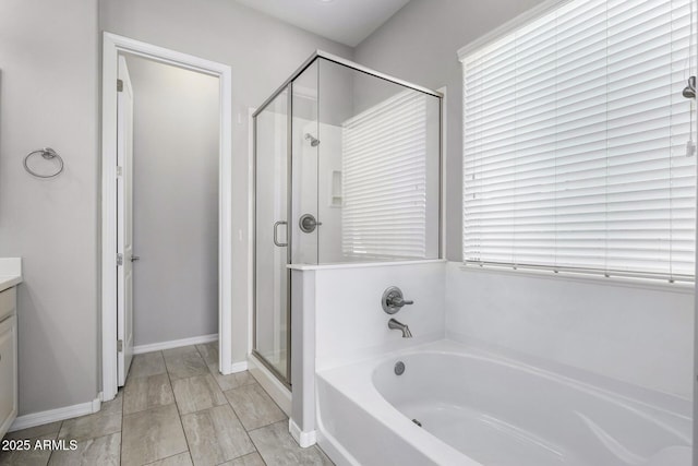 bathroom featuring vanity and shower with separate bathtub