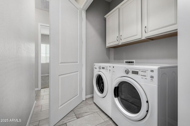 washroom with cabinets and washer and clothes dryer