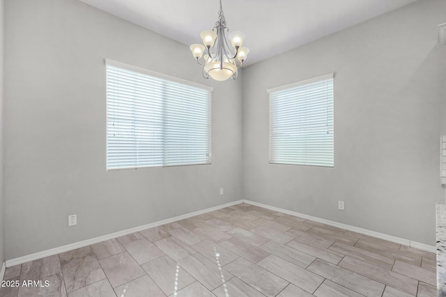 empty room featuring a notable chandelier