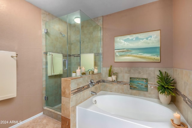 bathroom featuring tile patterned floors and shower with separate bathtub