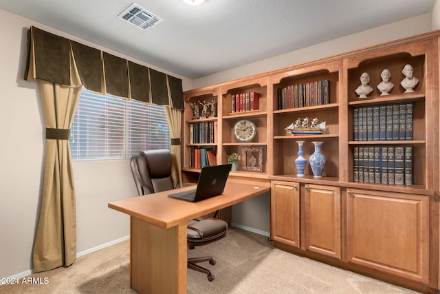 carpeted home office with a textured ceiling