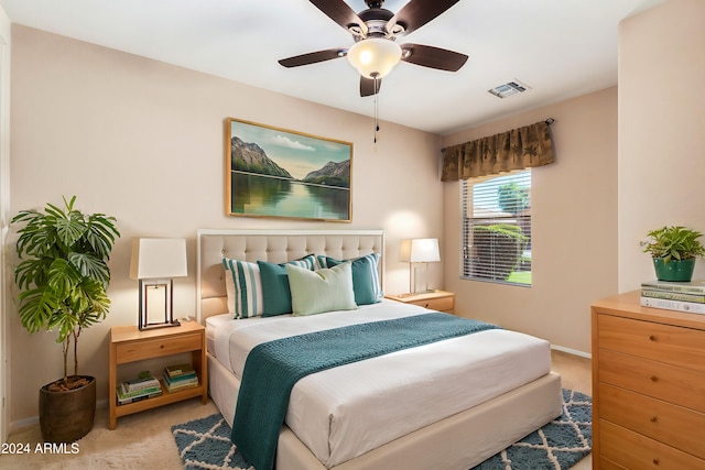 bedroom featuring light carpet and ceiling fan