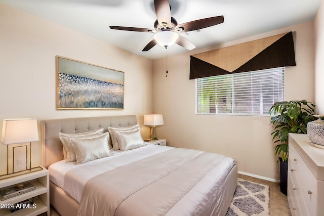 bedroom featuring light carpet and ceiling fan