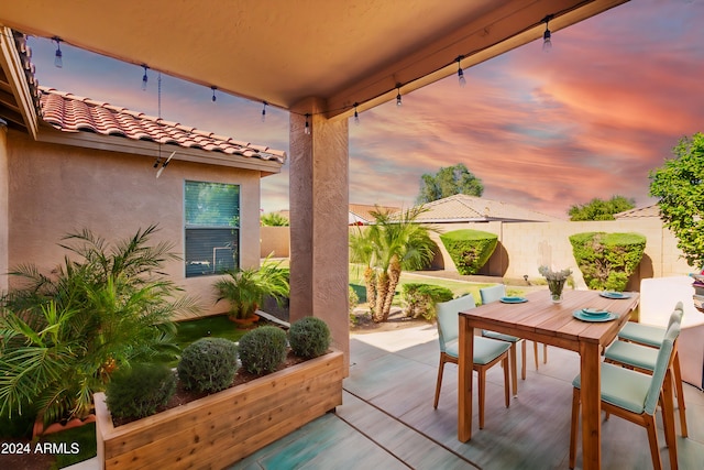 view of patio terrace at dusk