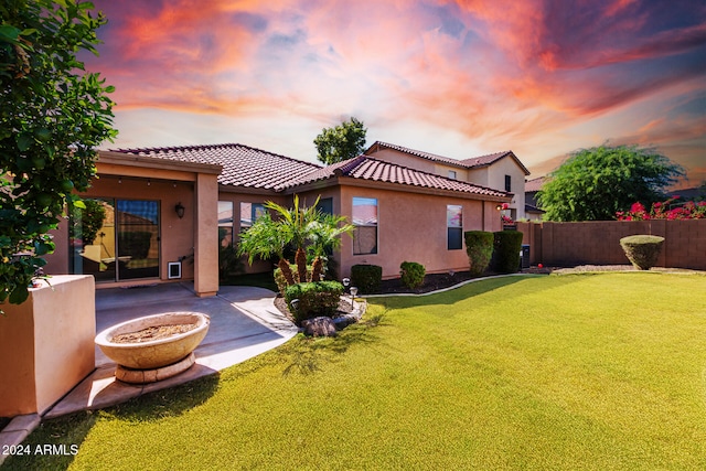 yard at dusk with a patio area