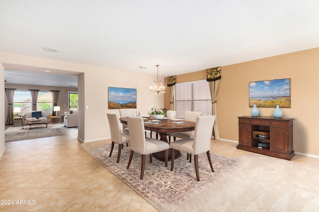 dining room with a notable chandelier and light tile patterned floors