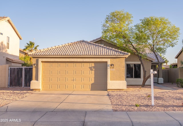 15067 W Taylor St, Goodyear, AZ 85338 - single story home with stucco siding, concrete driveway, an attached garage, fence, and a tiled roof