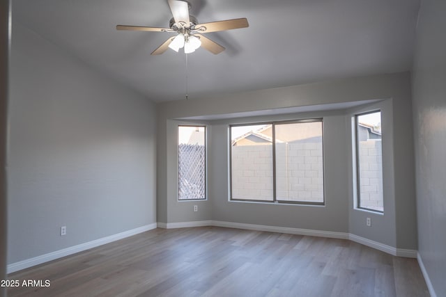 15067 W Taylor St, Goodyear, AZ 85338 - spare room with wood finished floors, baseboards, ceiling fan, and vaulted ceiling