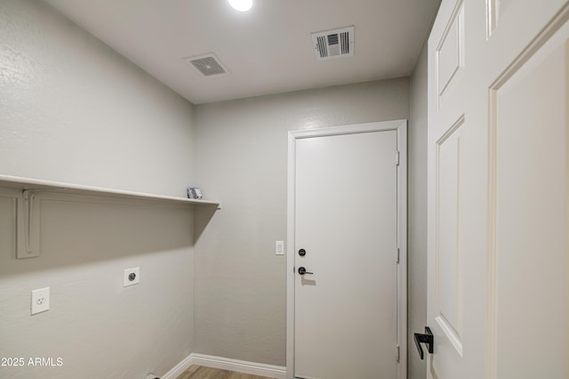 15067 W Taylor St, Goodyear, AZ 85338 - laundry room featuring electric dryer hookup, baseboards, and wood finished floors