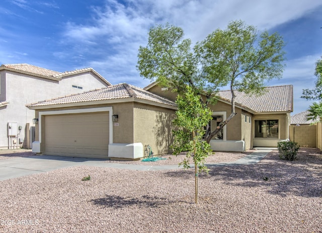 15067 W Taylor St, Goodyear, AZ 85338 - view of front of property with stucco siding, concrete driveway, a tile roof, and an attached garage