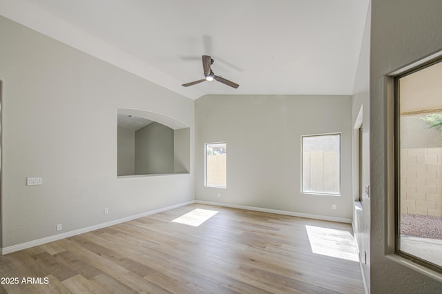 15067 W Taylor St, Goodyear, AZ 85338 - empty room featuring lofted ceiling, ceiling fan, light wood-style flooring, and baseboards