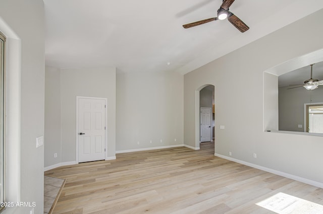 15067 W Taylor St, Goodyear, AZ 85338 - spare room with ceiling fan, arched walkways, wood finished floors, baseboards, and lofted ceiling