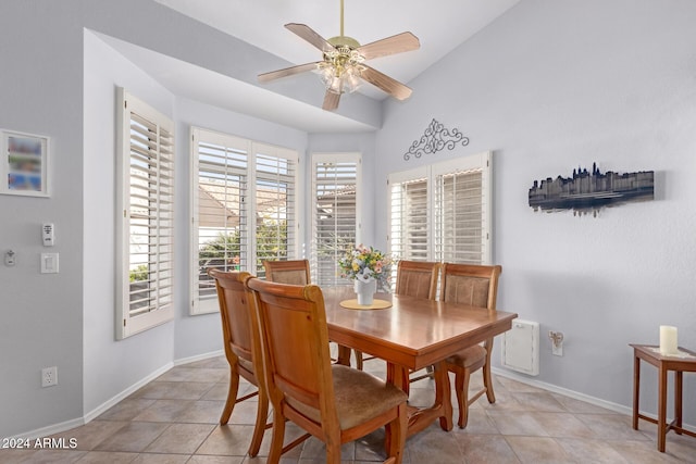 dining room with ceiling fan, light tile patterned floors, a wealth of natural light, and vaulted ceiling