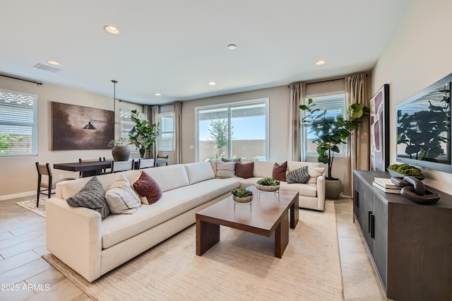 living area featuring plenty of natural light, recessed lighting, and light tile patterned floors