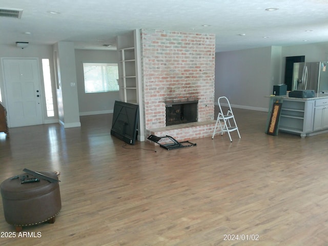 6139 E Voltaire Ave, Scottsdale, AZ 85254 - living area featuring light wood finished floors, a fireplace, and recessed lighting