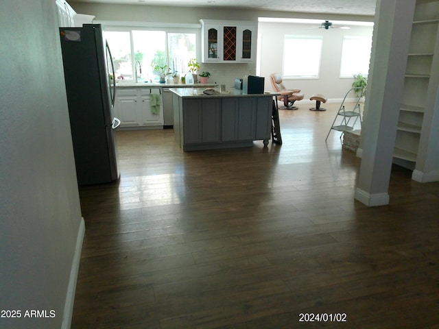 6139 E Voltaire Ave, Scottsdale, AZ 85254 - living area with plenty of natural light, dark wood-type flooring, and a ceiling fan