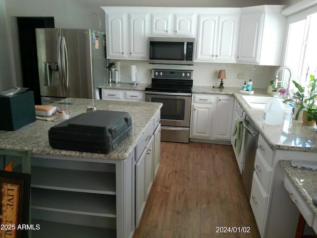 6139 E Voltaire Ave, Scottsdale, AZ 85254 - kitchen with stainless steel appliances, open shelves, white cabinets, wood finished floors, and light stone counters