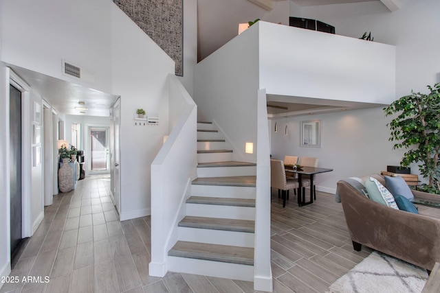 staircase with a towering ceiling