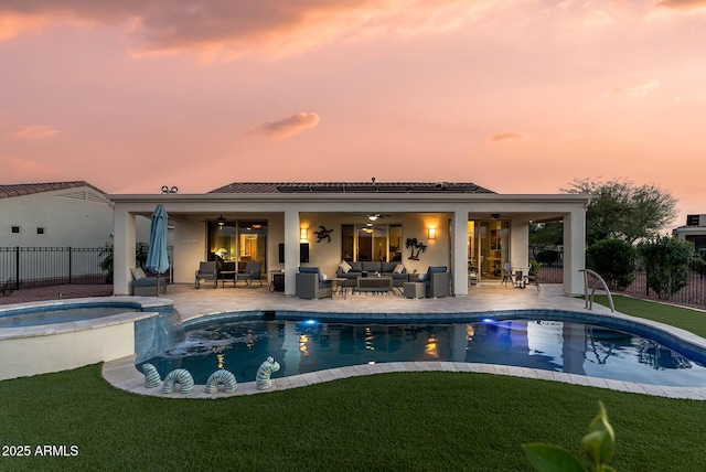 view of swimming pool featuring a yard, a patio area, fence, and an outdoor hangout area