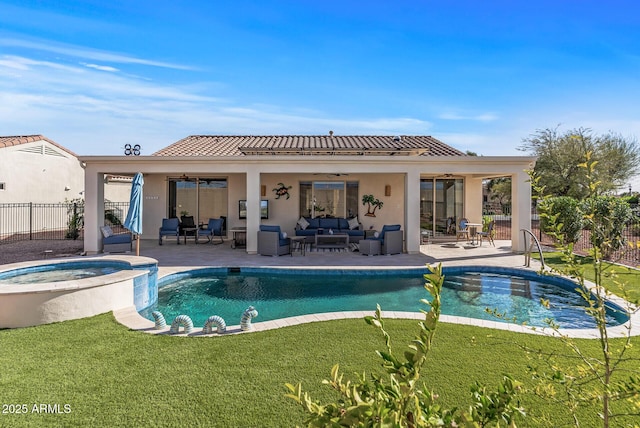 rear view of house with a patio, stucco siding, a lawn, fence, and an outdoor living space