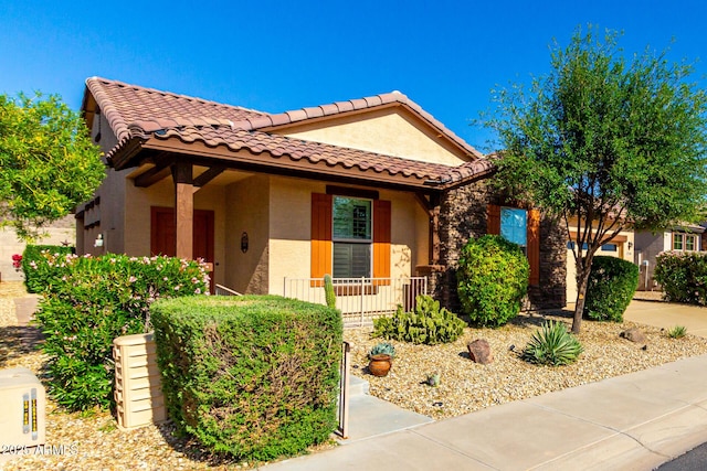 17139 S 174th Dr, Goodyear, AZ 85338 - mediterranean / spanish home featuring a tiled roof, stucco siding, and stone siding