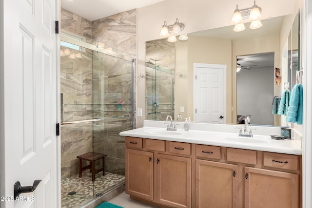 17139 S 174th Dr, Goodyear, AZ 85338 - full bathroom featuring double vanity, a ceiling fan, a sink, and a stall shower