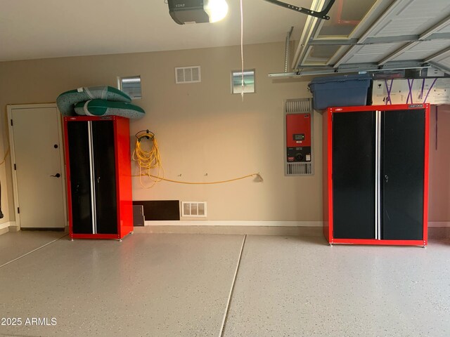 17139 S 174th Dr, Goodyear, AZ 85338 - garage with visible vents, baseboards, and a garage door opener