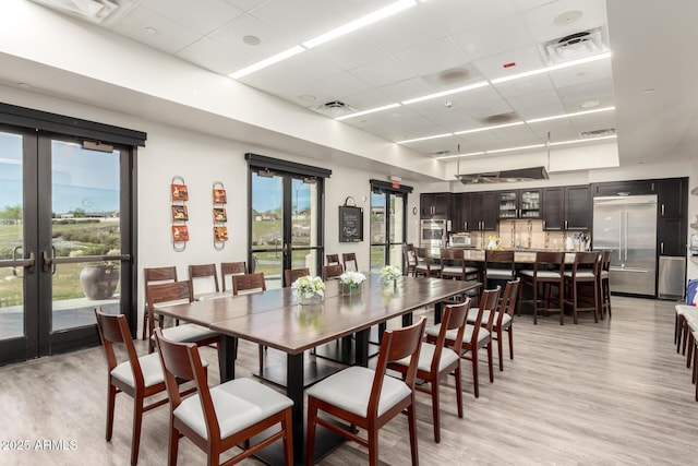 17139 S 174th Dr, Goodyear, AZ 85338 - dining space with french doors, light wood finished floors, a drop ceiling, and visible vents