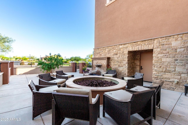17139 S 174th Dr, Goodyear, AZ 85338 - view of patio with a fire pit, a fireplace, and fence