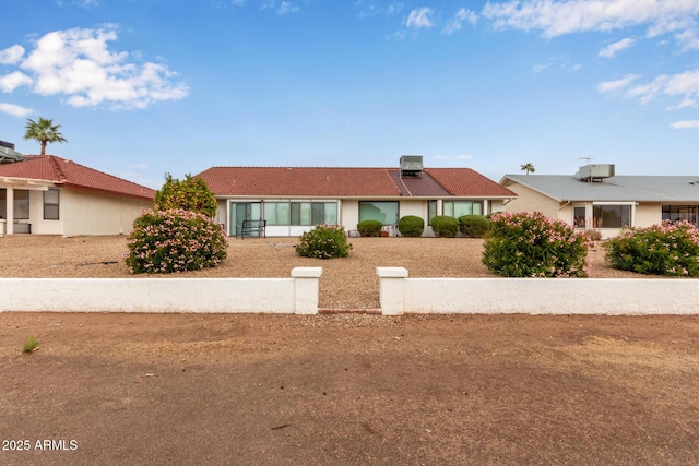 ranch-style house featuring a tiled roof