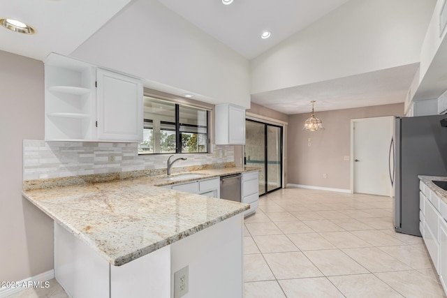 kitchen with light tile patterned floors, appliances with stainless steel finishes, white cabinetry, and a sink