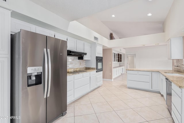 kitchen featuring oven, stainless steel refrigerator with ice dispenser, under cabinet range hood, a sink, and light tile patterned floors