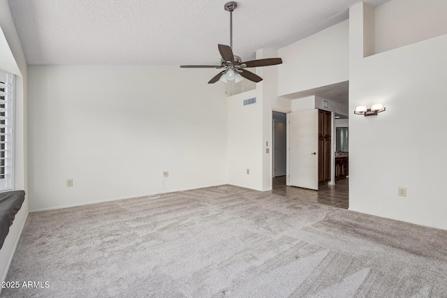 unfurnished living room featuring carpet flooring, ceiling fan, a textured ceiling, and visible vents