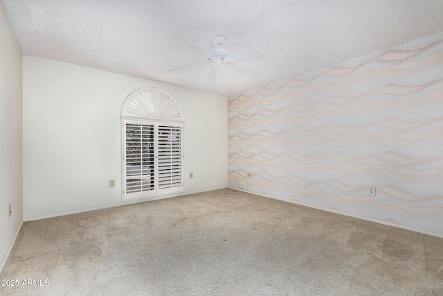 empty room featuring ceiling fan and carpet flooring