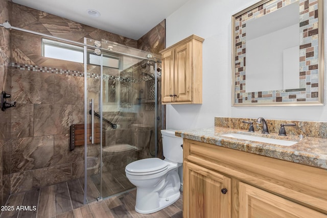 full bath with toilet, a shower stall, and vanity