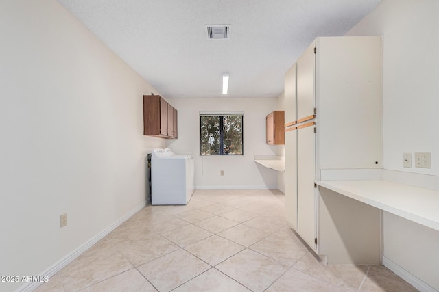 laundry room featuring visible vents, washer / dryer, light tile patterned flooring, cabinet space, and a textured ceiling