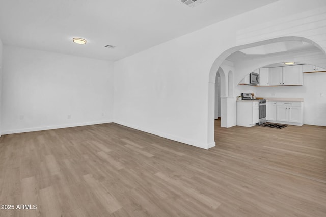 538 S Macdonald, Mesa, AZ 85210 - unfurnished living room featuring light wood-style floors and arched walkways