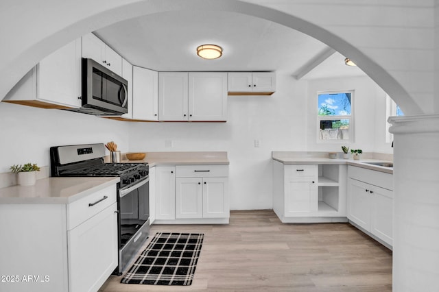 538 S Macdonald, Mesa, AZ 85210 - kitchen featuring stainless steel appliances, open shelves, arched walkways, and white cabinetry
