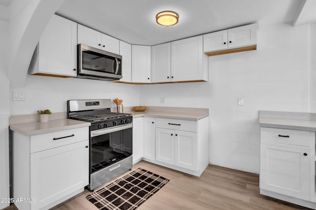 538 S Macdonald, Mesa, AZ 85210 - kitchen featuring stainless steel appliances, light countertops, white cabinets, and light wood finished floors