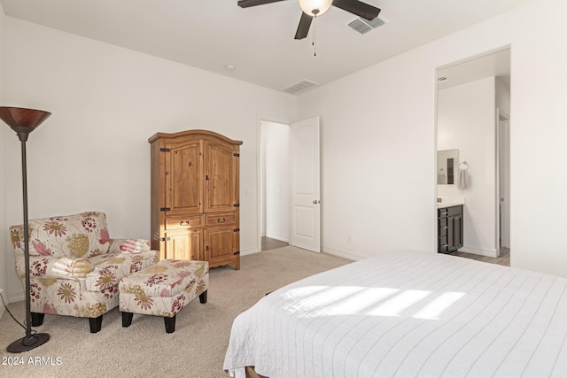 carpeted bedroom with ceiling fan and ensuite bathroom