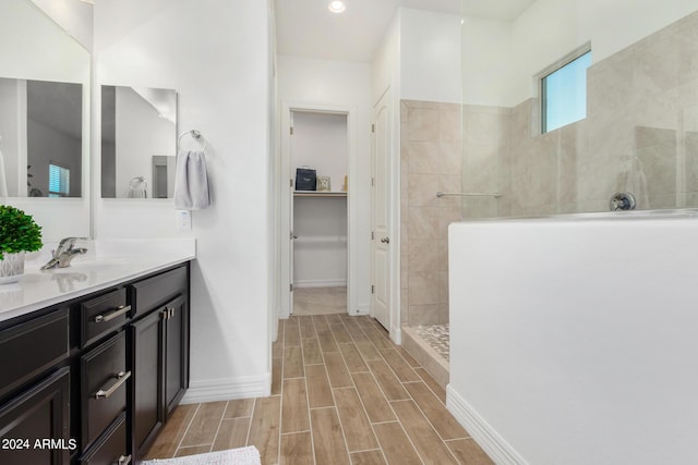 bathroom featuring vanity and tiled shower