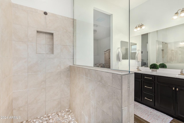 bathroom featuring vanity and a tile shower