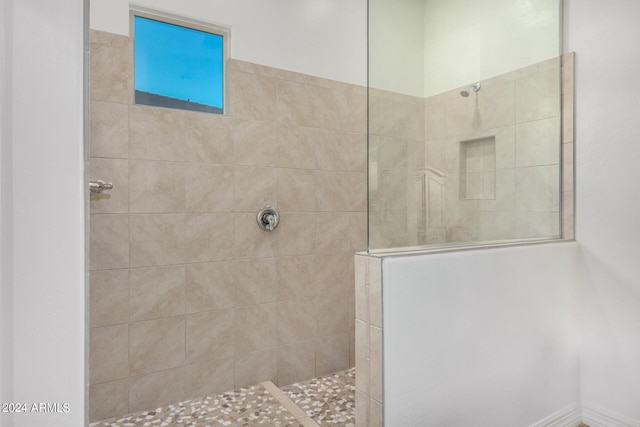 bathroom with a tile shower