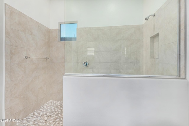 bathroom with tiled shower