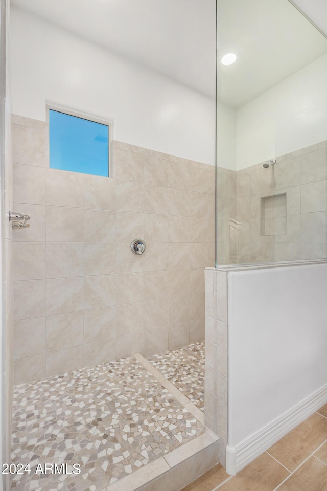 bathroom with tiled shower