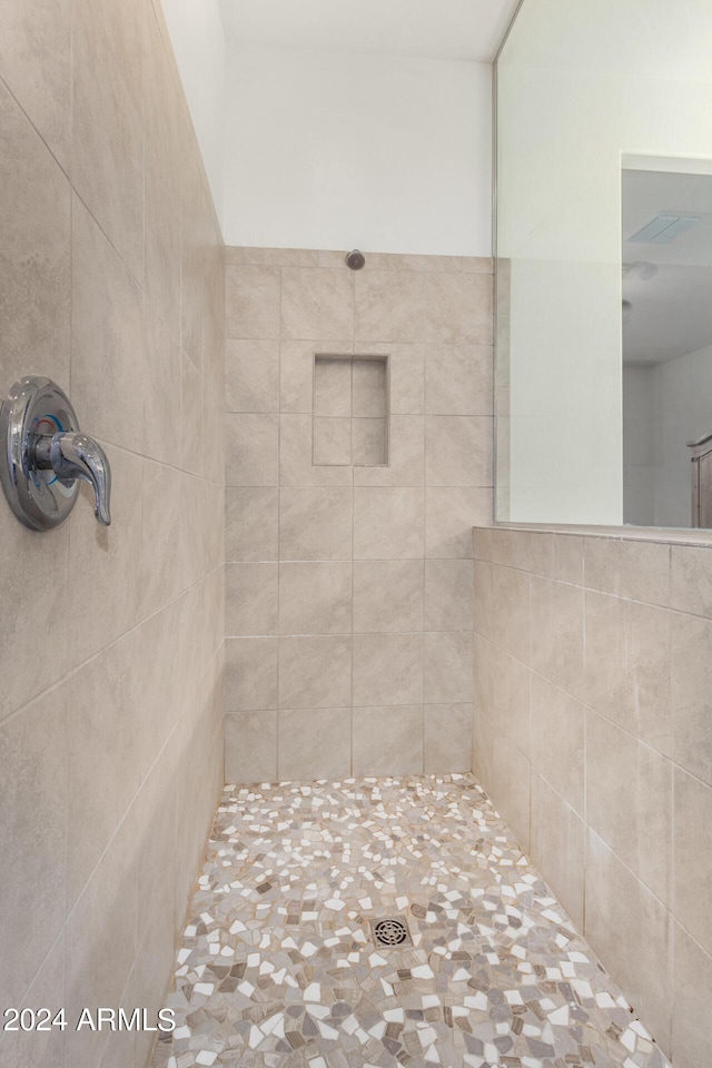 bathroom with tiled shower