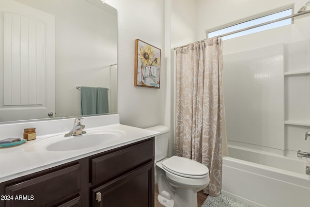 full bathroom with vanity, shower / bath combination with curtain, and toilet