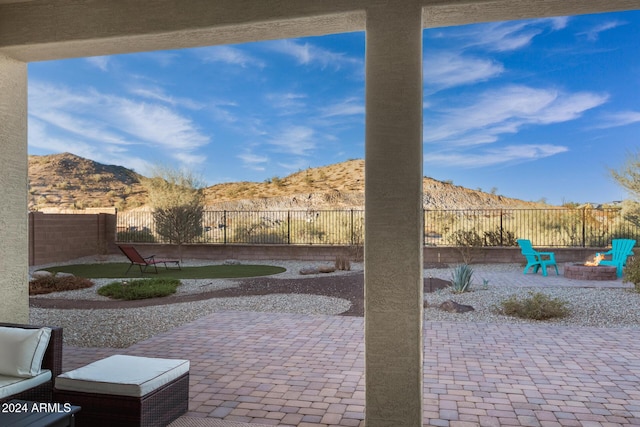 view of patio featuring a mountain view and a fire pit